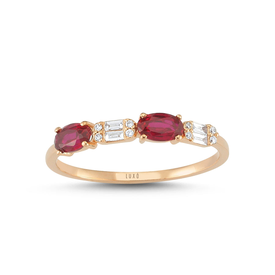 Rose gold ring with two ruby gemstones that sit beside baguette and round-cut diamonds