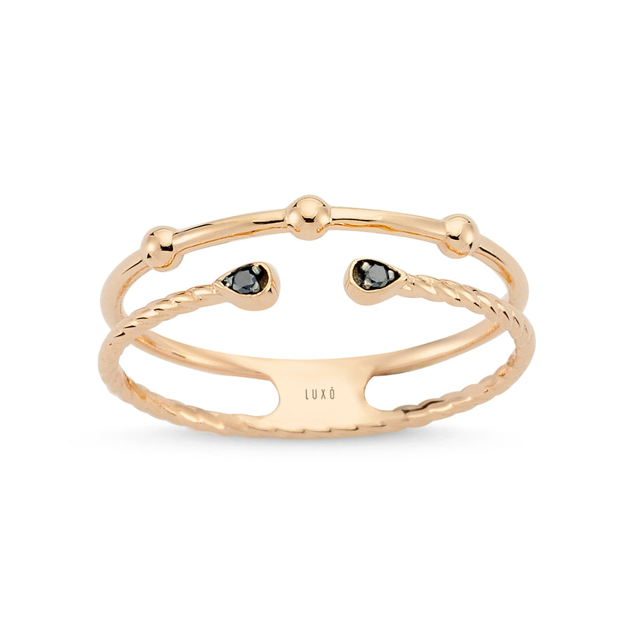 Rose gold ring featuring a double band adorned with black diamonds
